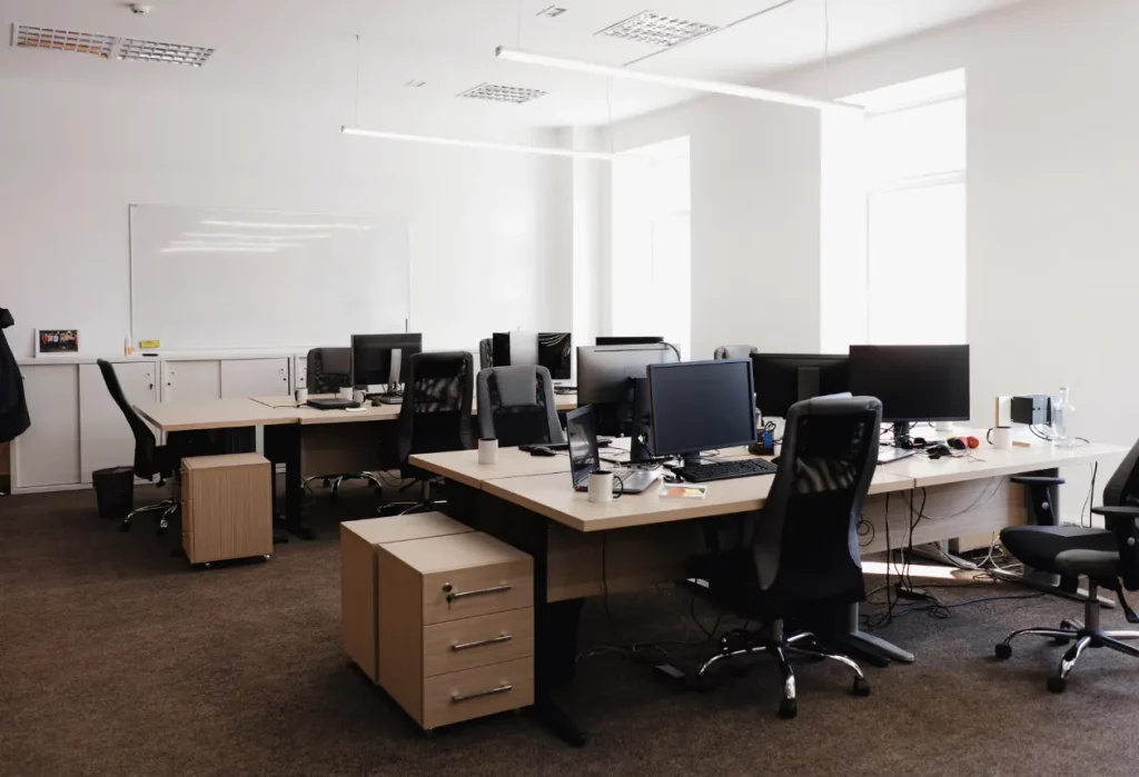 Office with desks, storage units and a whiteboard